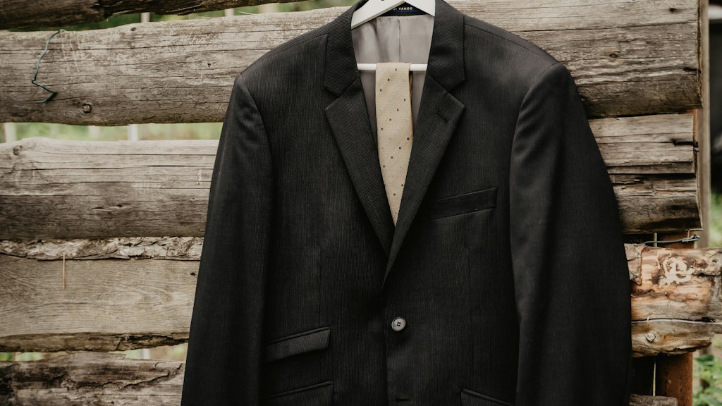 Black suit jacket hanging on a clothes hanger